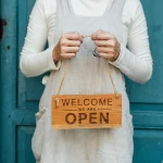 Person holding a welcome sign representing new member onboarding