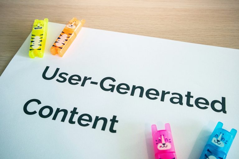 User generated content concept desk with UGC sign representing member-created visual content in BuddyPress