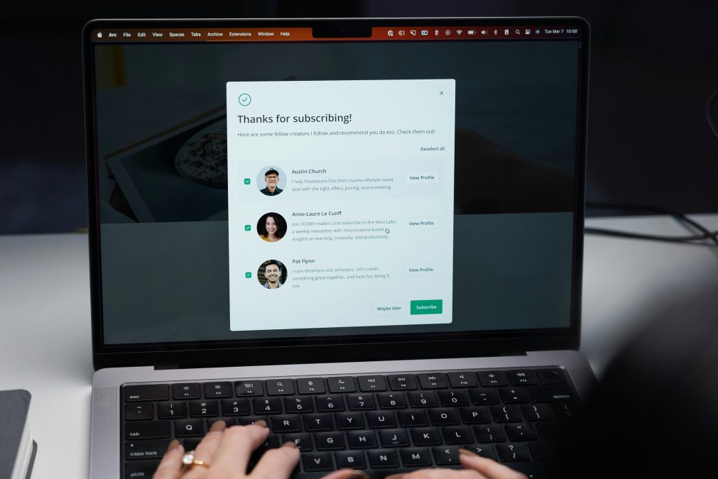 Person working on laptop considering adding a discussion board to their WordPress website