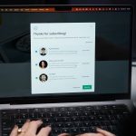 Person working on laptop considering adding a discussion board to their WordPress website