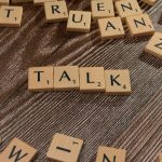 Wooden letter tiles spelling Talk representing different community discussion formats