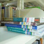 Stack of organized books representing a structured knowledge base built from community Q&A content