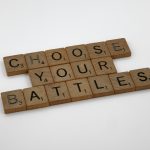 Scrabble tiles spelling Choose Your Battles representing community voting on product roadmap ideas