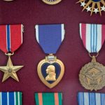 Collection of medals and badges on display representing gamification achievements in community forums