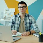 Student studying at desk with laptop representing online course discussion forums for LearnDash