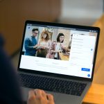 Laptop on desk showing online community notifications and mentions in a forum