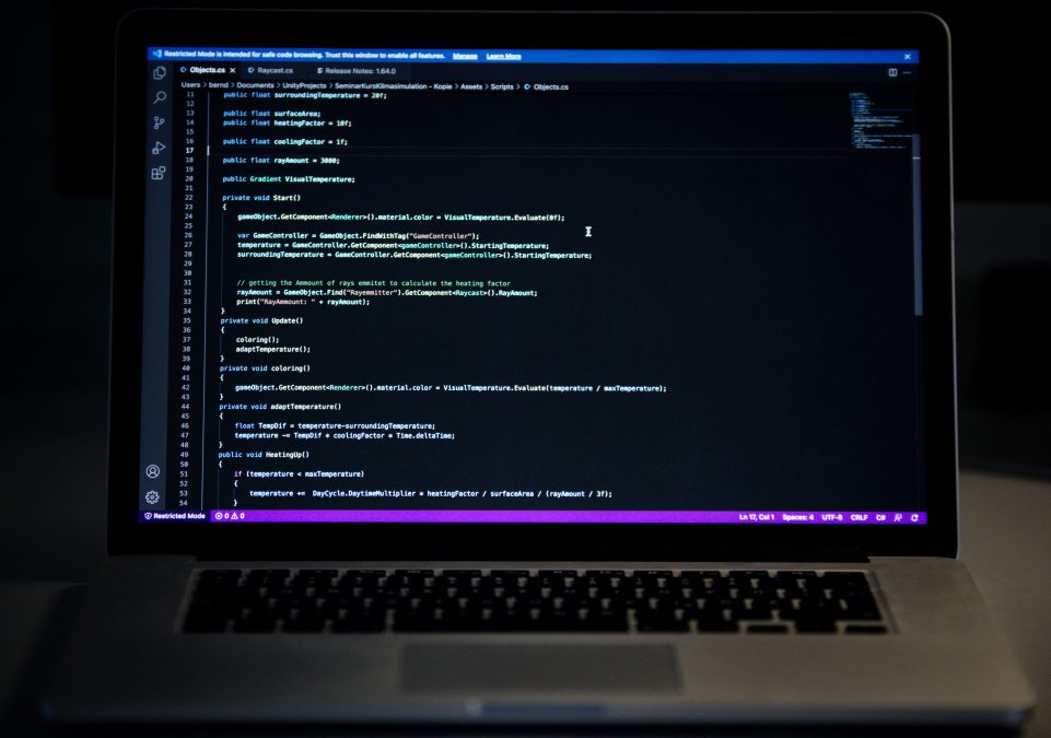 Laptop on desk with code representing SEO schema markup configuration for WordPress forums